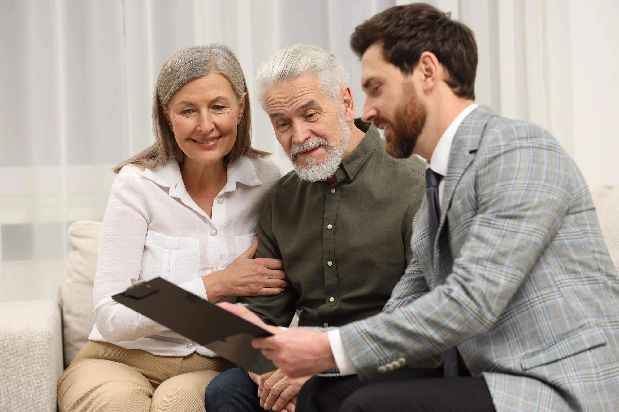 Attorney assisting an elderly man and his daughter with guardianship and conservatorship documents.