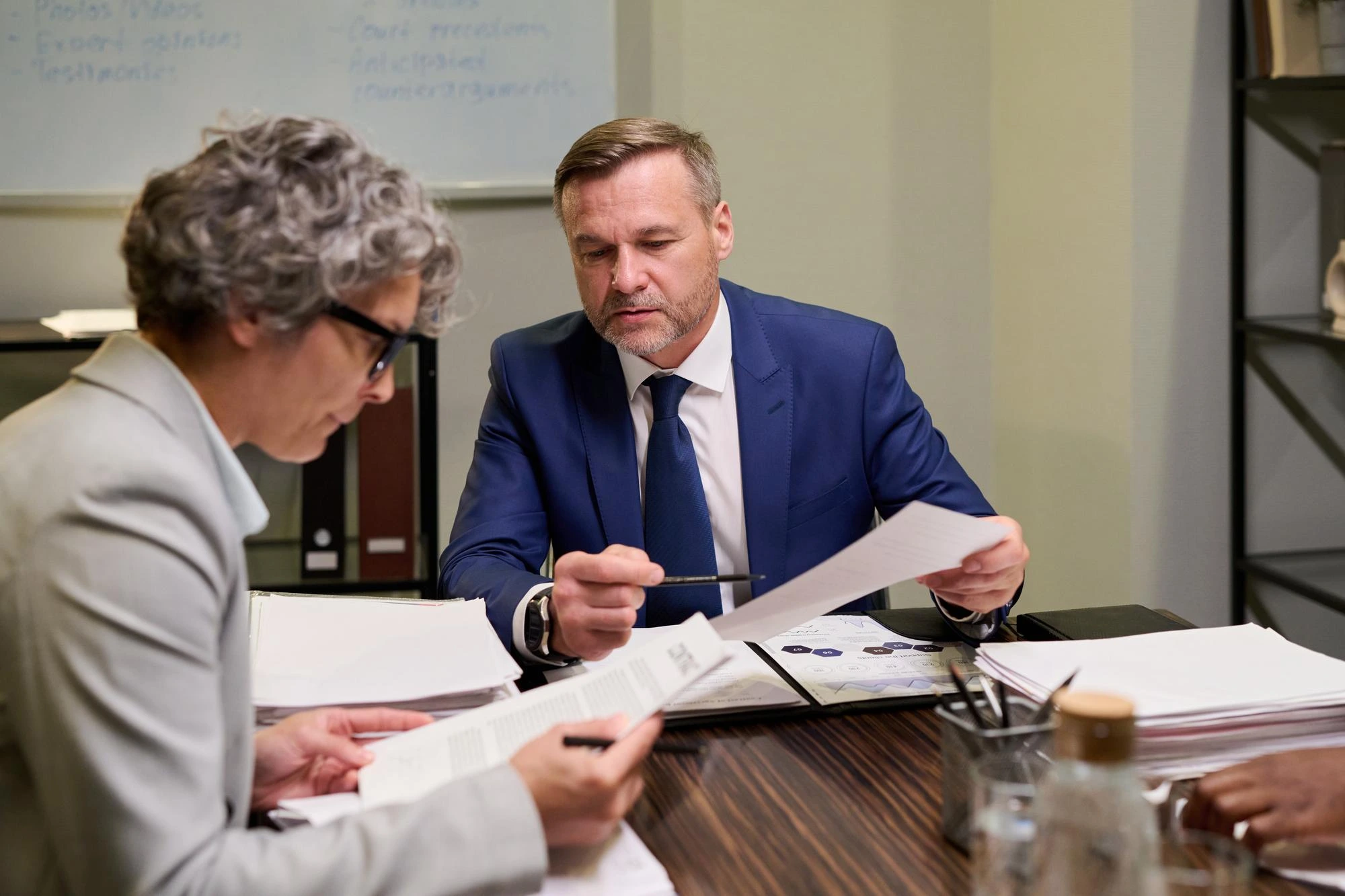 Attorney reviewing legal documents with a client in a law office.